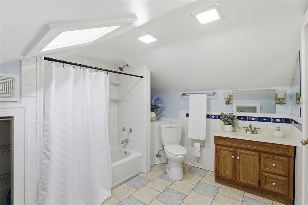 216 Northeast 6th Street Gainesville, FL 32601 - Photo 29 of 36 a spacious bathroom with a double vanity sink a mirror and a bathtub