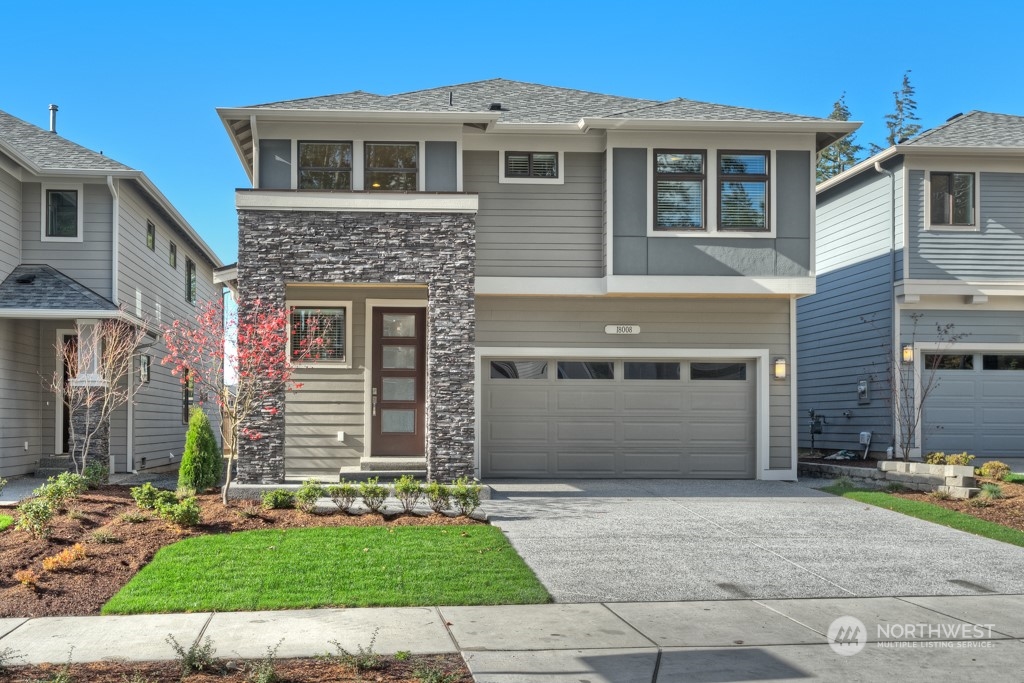 2 177th St S Street West, Unit IW 88 Bothell, WA 98012 - Photo 1 of 26 a front view of a house with a garden and garage