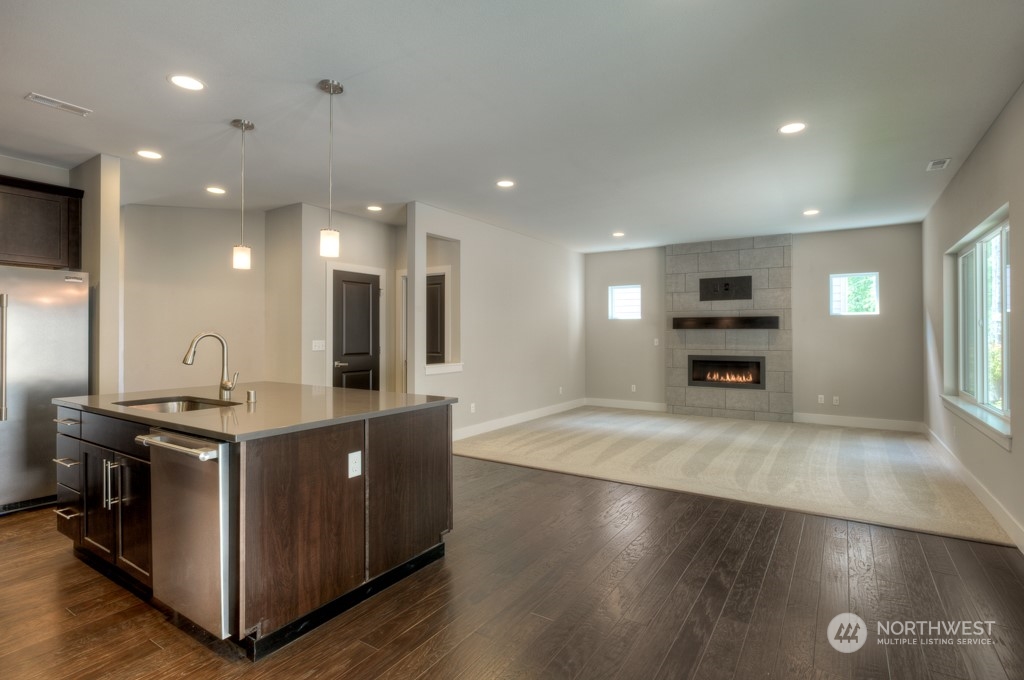 2 177th St S Street West, Unit IW 88 Bothell, WA 98012 - Photo 11 of 26 a kitchen with stainless steel appliances granite countertop a sink a stove and a refrigerator