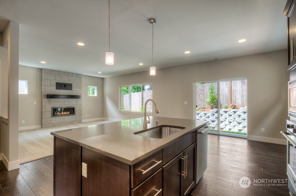 2 177th St S Street West, Unit IW 88 Bothell, WA 98012 - Photo 7 of 26 a kitchen with stainless steel appliances granite countertop a sink a stove and a wooden floors