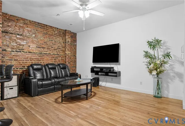a living room with furniture a chandelier and a dining table
