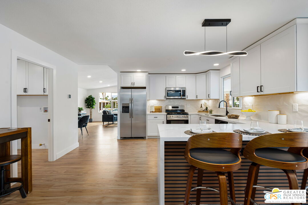 142 Capri Rancho Mirage, CA 92270 - Photo 12 of 26 a kitchen with granite countertop a stove a sink and a refrigerator