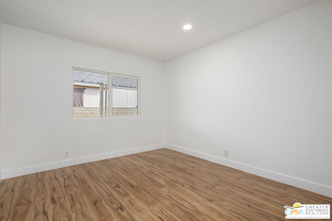 142 Capri Rancho Mirage, CA 92270 - Photo 14 of 26 wooden floor in an empty room