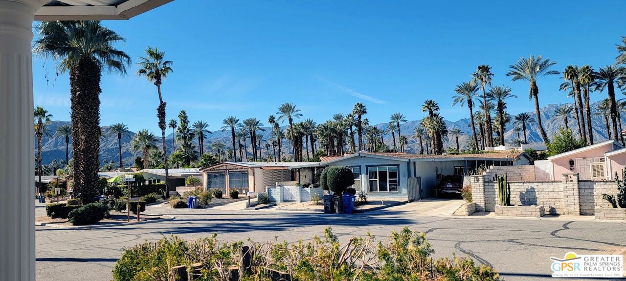 142 Capri Rancho Mirage, CA 92270 - Photo 18 of 26 a front view of a building with garden and trees