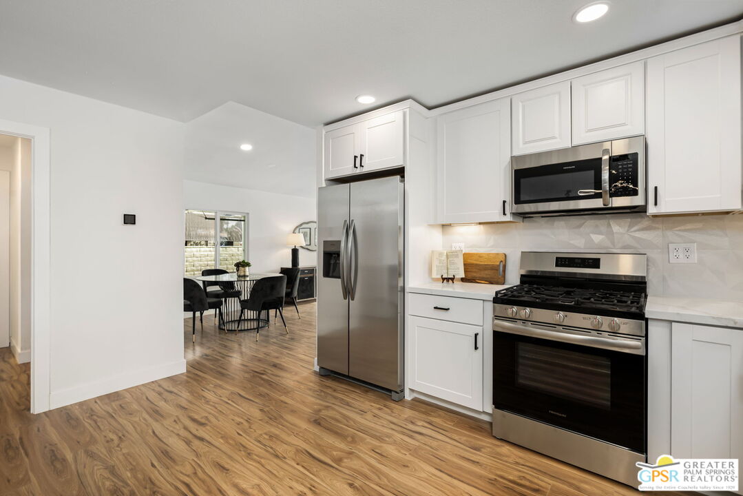 142 Capri Rancho Mirage, CA 92270 - Photo 5 of 26 a kitchen with stainless steel appliances a stove microwave and refrigerator