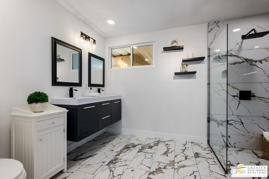 142 Capri Rancho Mirage, CA 92270 - Photo 10 of 26 a spacious bathroom with a bathtub sink and mirror