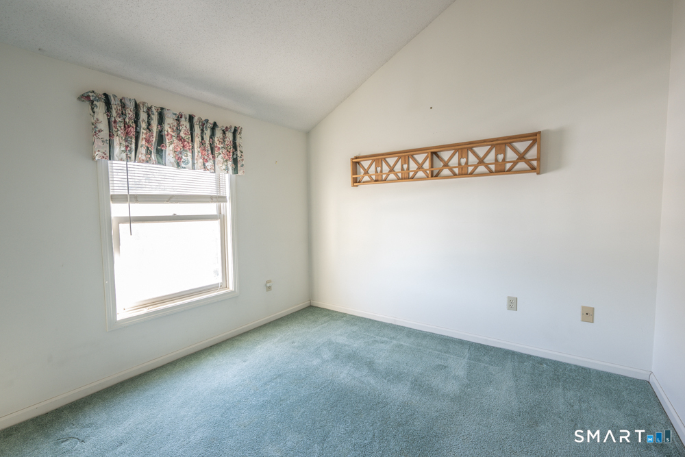 565 Newfield Street, Unit 34 Middletown, CT 06457 - Photo 11 of 17 Spacious secondary bedroom with its own full bathroom, offering privacy and flexibility for guests or everyday living.