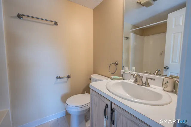 a bathroom with a sink toilet and a mirror