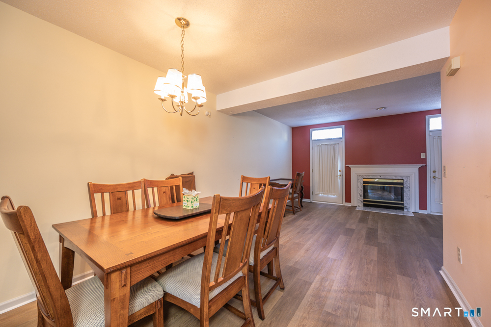 565 Newfield Street, Unit 34 Middletown, CT 06457 - Photo 4 of 17 Imagine this table filled with conversation, laughter, and lingering dinners-just steps from the warmth of the fireplace.