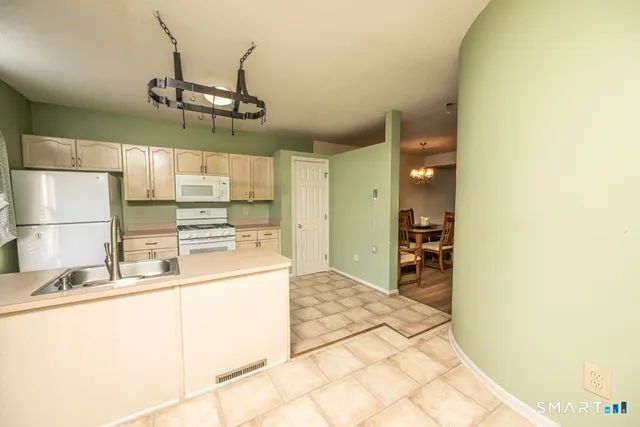a kitchen with stainless steel appliances granite countertop a sink and cabinets