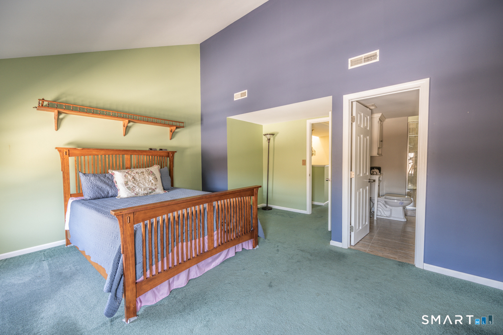 565 Newfield Street, Unit 34 Middletown, CT 06457 - Photo 8 of 17 Spacious primary bedroom with updated en suite bath, offering comfort, privacy, and a peaceful place to recharge.