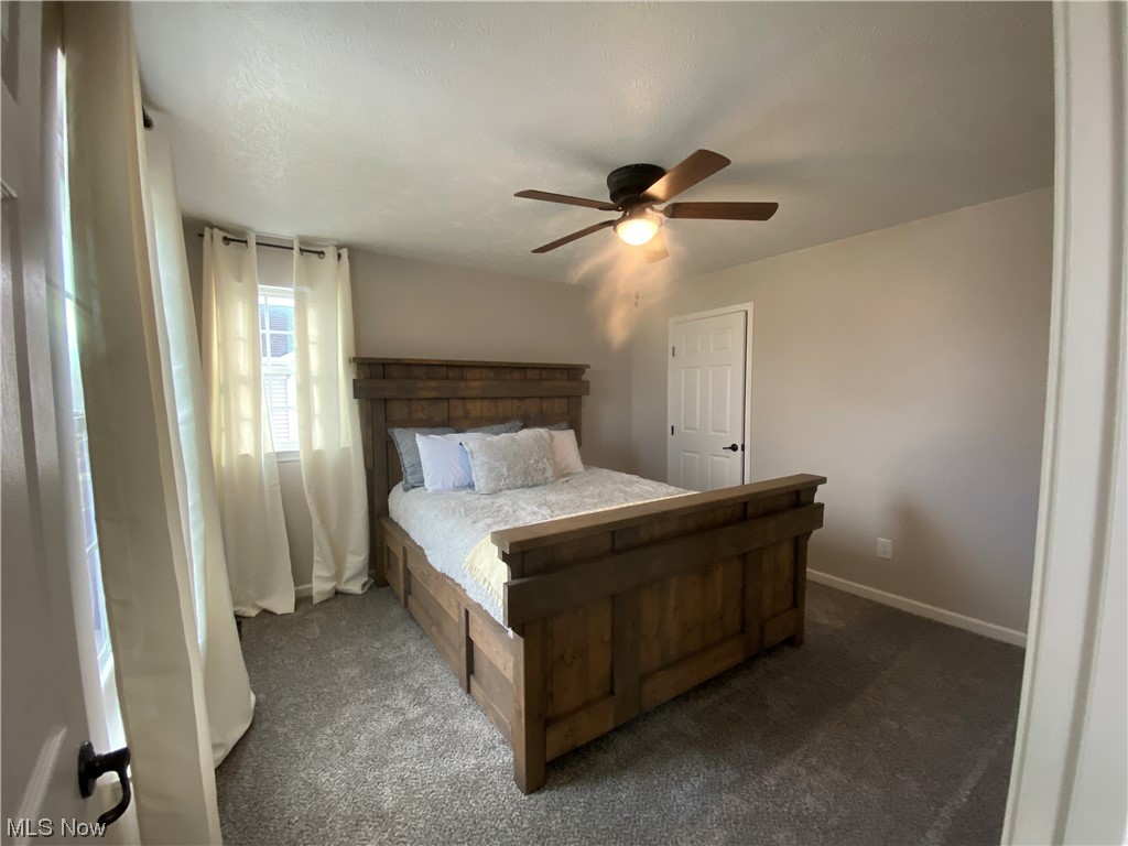 2113 Fowl Road Elyria, OH 44035 - Photo 19 of 39 First Bedroom with dark colored carpet and ceiling fan, nice sized closet