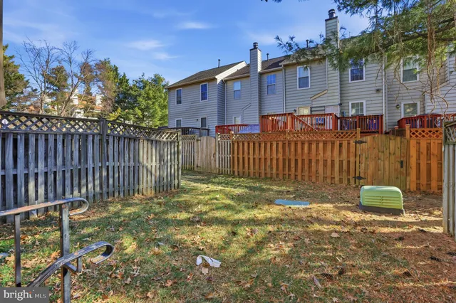 a view of a house with wooden fence