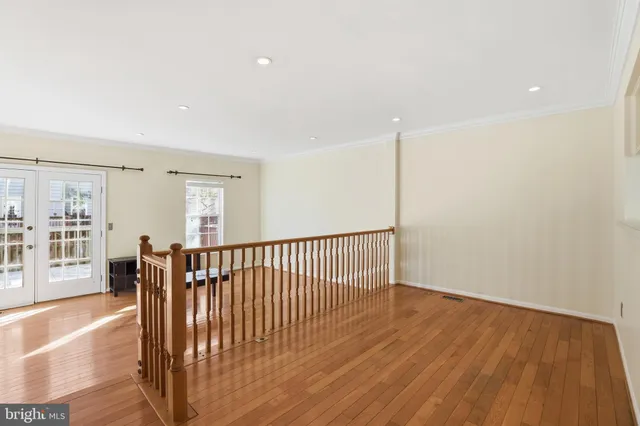 a view of a room with wooden floor and windows