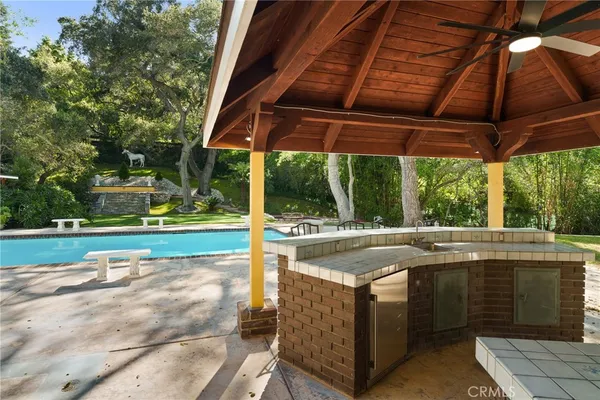 a view of a patio with a table chairs and a backyard