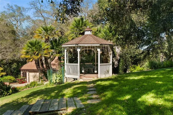 a view of a house with yard and sitting area