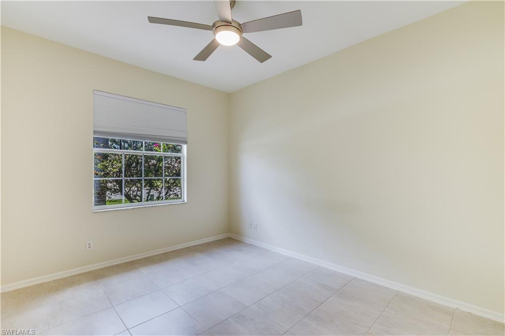 160 Stanhope Circle Naples, FL 34104 - Photo 11 of 17 an empty room with a window and a fan