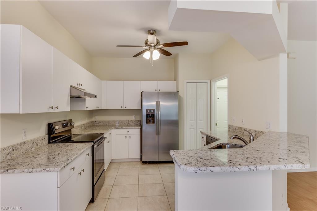 160 Stanhope Circle Naples, FL 34104 - Photo 3 of 17 a kitchen with a granite countertop refrigerator a sink and dishwasher