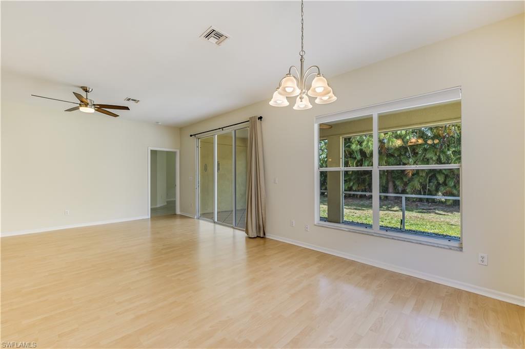 160 Stanhope Circle Naples, FL 34104 - Photo 4 of 17 a view of a livingroom with a chandelier fan and windows