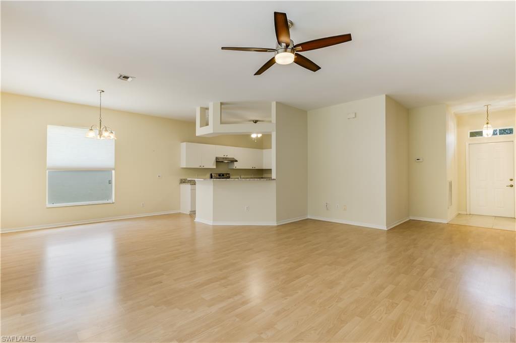 160 Stanhope Circle Naples, FL 34104 - Photo 6 of 17 a view of empty room with wooden floor and window