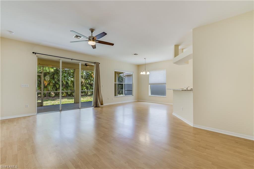160 Stanhope Circle Naples, FL 34104 - Photo 7 of 17 wooden floor in an empty room with a window