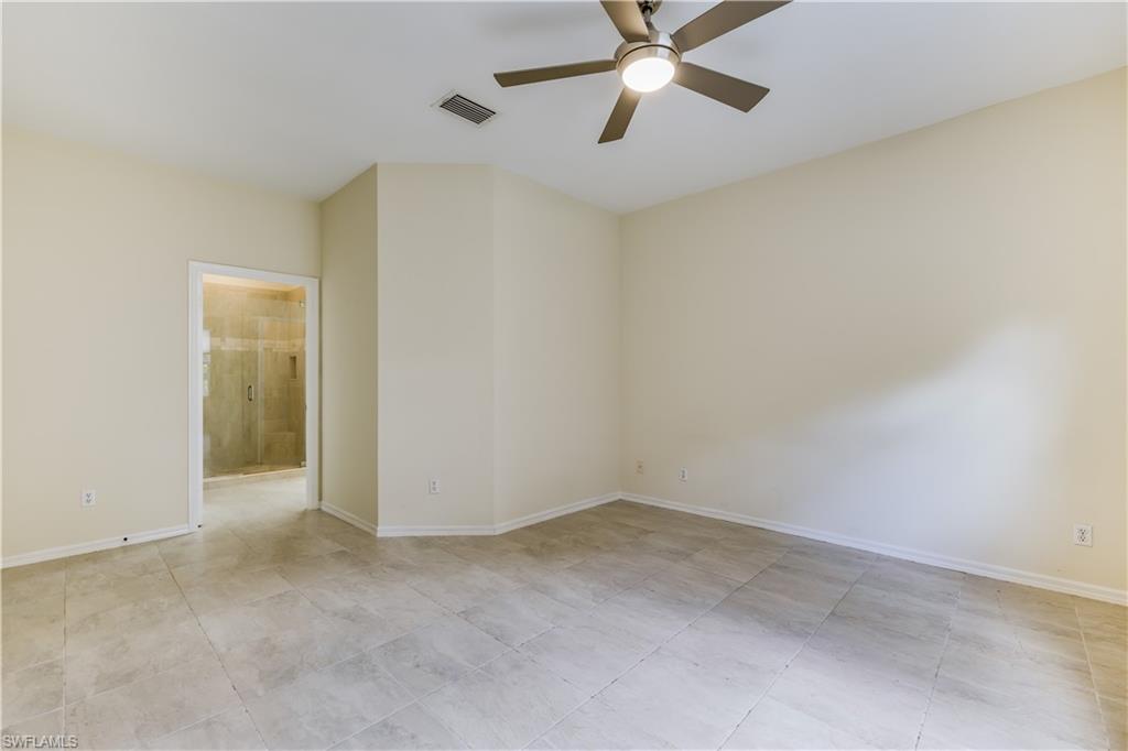 160 Stanhope Circle Naples, FL 34104 - Photo 9 of 17 an empty room with a window and a fan