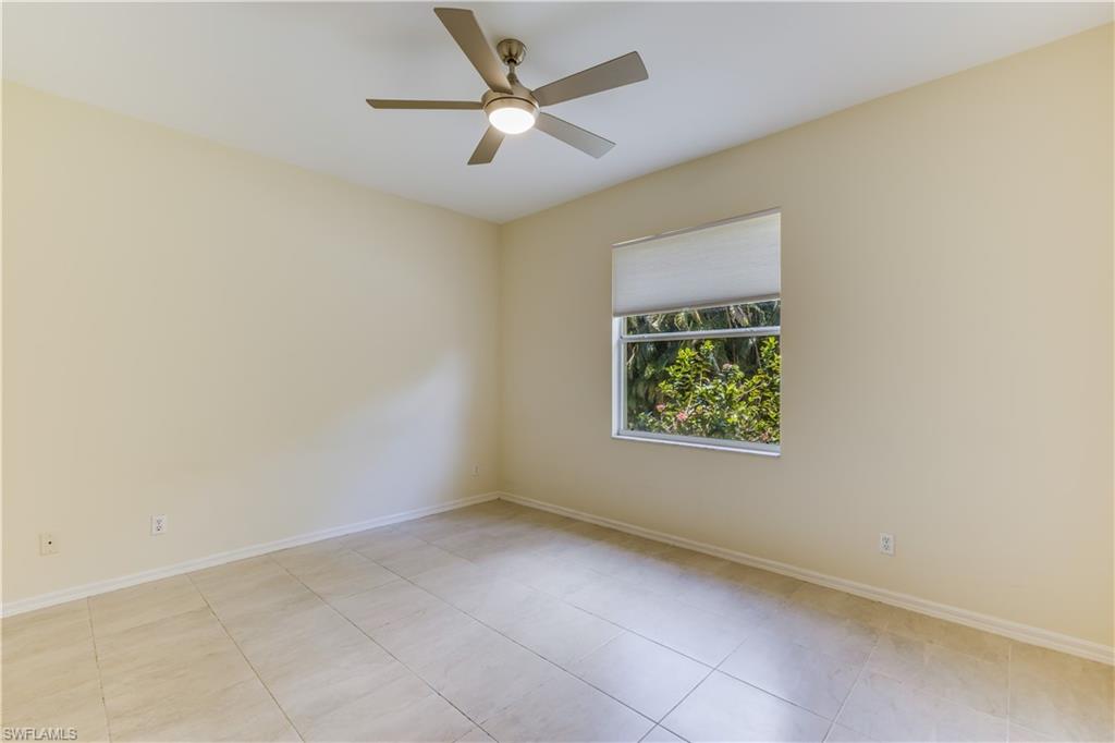 160 Stanhope Circle Naples, FL 34104 - Photo 10 of 17 an empty room with a window and a fan