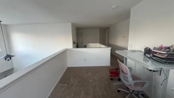 a large bed sitting in a bedroom next to a window and a chandelier