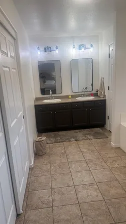 a bedroom with a bed and flat screen tv