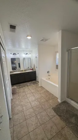 a bedroom with a bed and a table