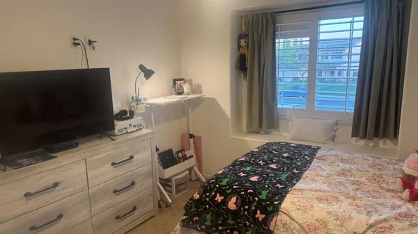 a bedroom with a bed and a window