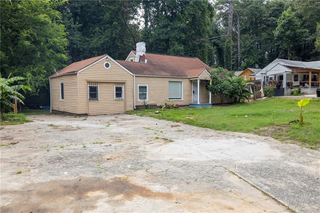 3838 Old Gordon Road Northwest Atlanta, GA 30336 - Photo 2 of 23 a front view of a house with a garden