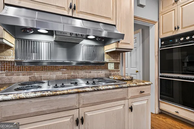 a living room with furniture a flat screen tv and a large window
