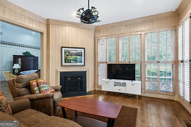 a living room with furniture ceiling fan and a window