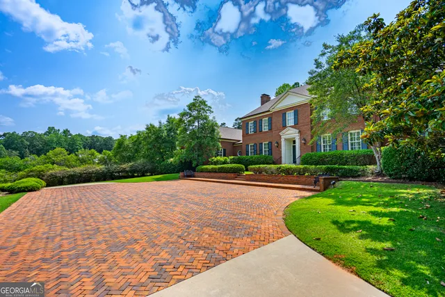 a view of a hallway with a black and white checkered floor