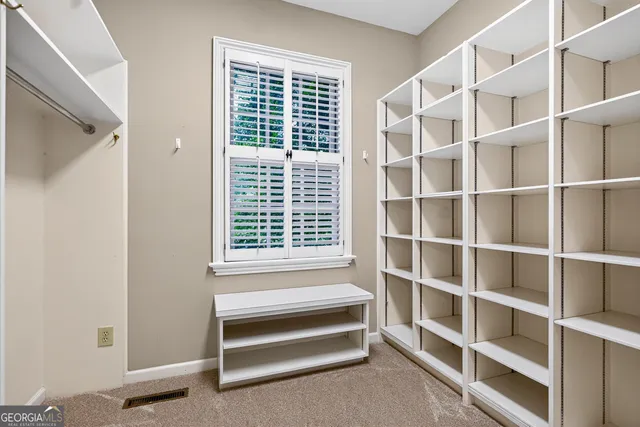 a front view of a building with a garden