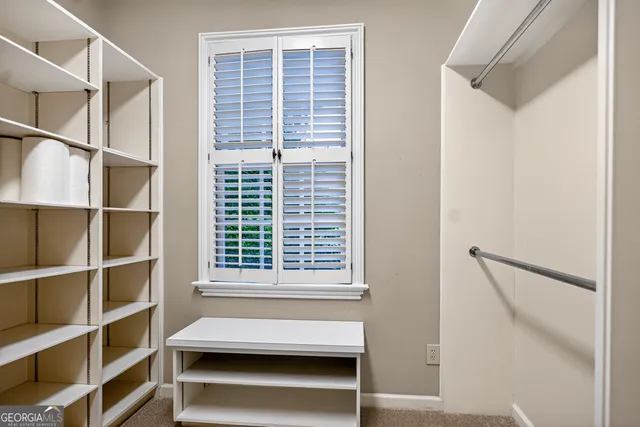 an aerial view of a house with a yard and lake view