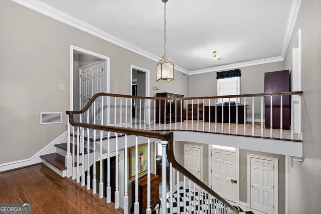 an aerial view of a house with a yard and a large tree