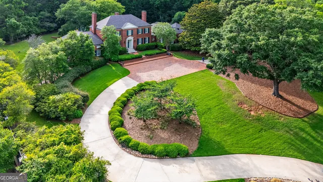 a kitchen with stainless steel appliances granite countertop a stove a sink dishwasher a dining table and chairs with wooden floor