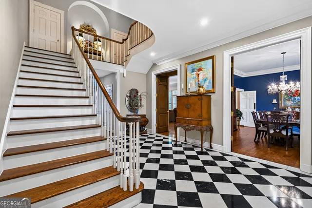 a kitchen with granite countertop a table chairs a stove a dining table and chairs