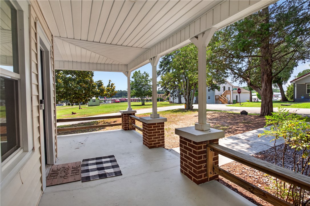 115 Pelfrey Street Seneca, SC 29672 - Photo 32 of 46 A welcoming covered porch offers tranquil neighborhood views, ideal for morning coffee or evening relaxation.