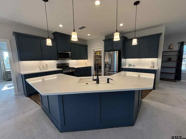 a kitchen with wooden floors and wooden cabinets