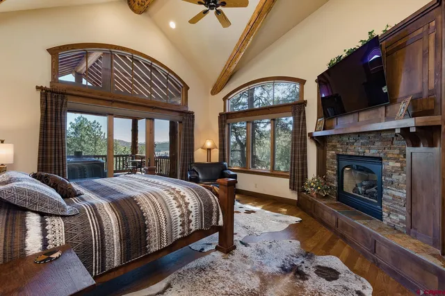 a bed sitting in a spacious bedroom next to a fireplace