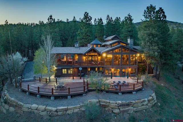 an aerial view of a house with garden space and sitting area