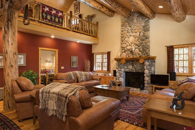 a living room with furniture fireplace and a chandelier