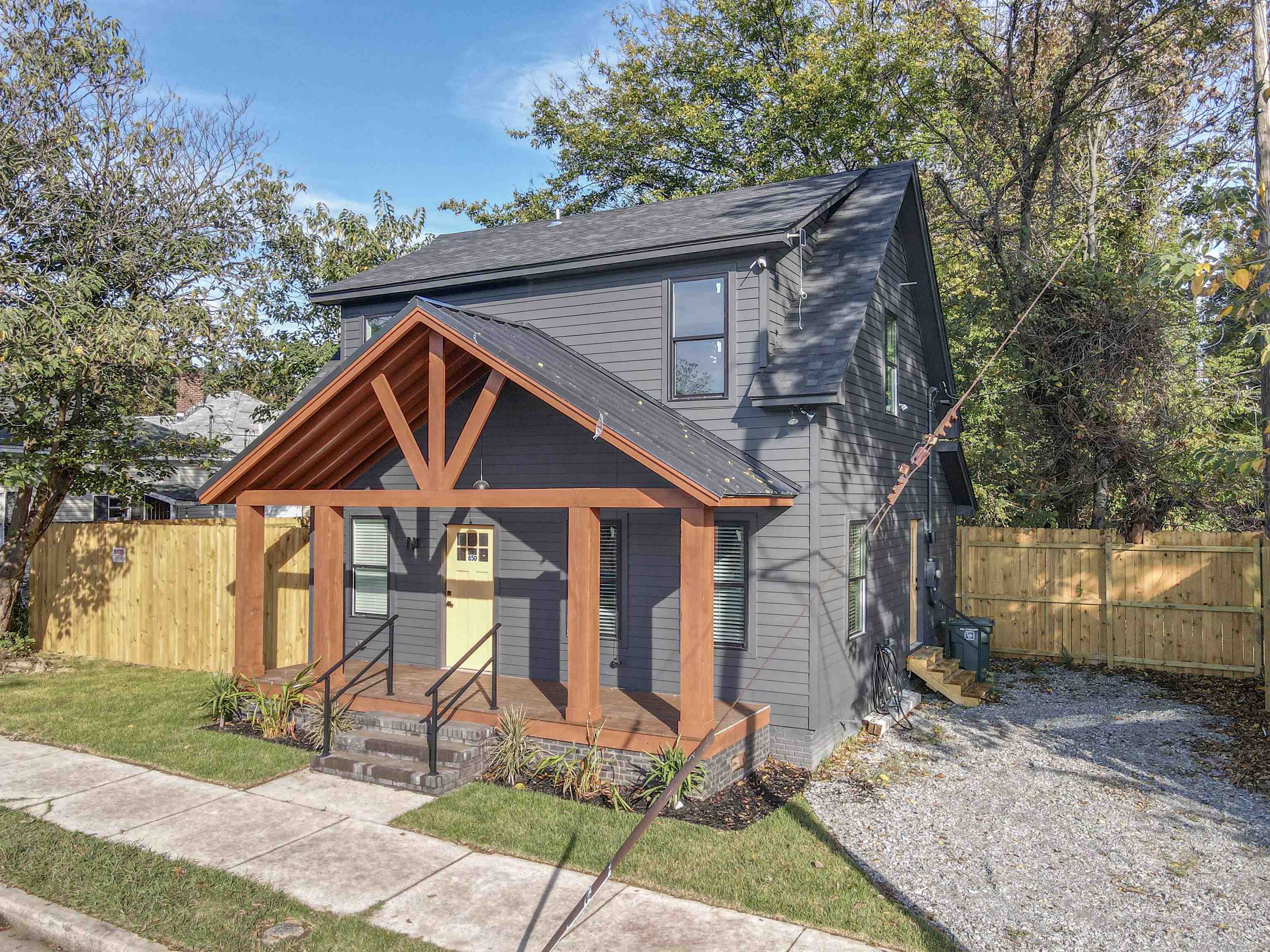 View of front of property featuring covered porch and a shingled roof