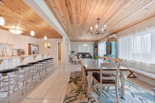 a dining room with furniture window and wooden floor