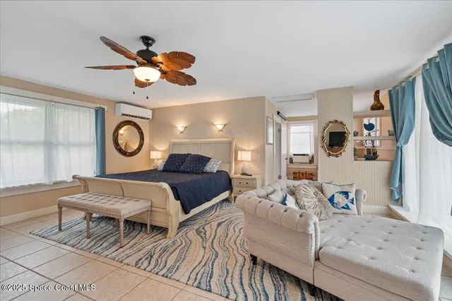 a view of a patio with couches table and chairs under an umbrella