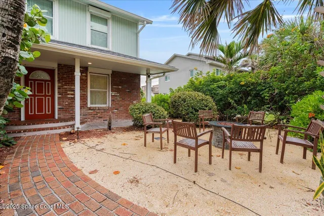 a view of a livingroom with furniture a rug wooden floor and windows