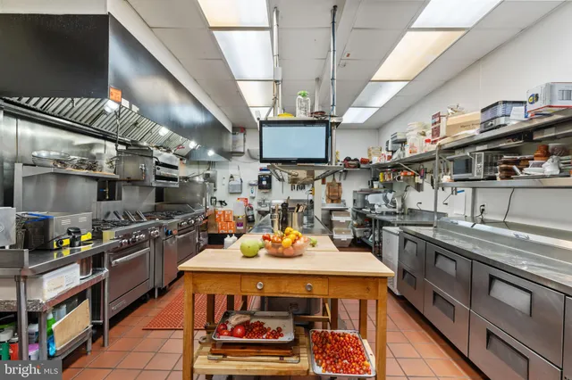 a kitchen with lots of counter top space and stainless steel appliances